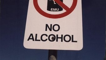 A white sign with the words  EMU and NO ALCOHOL