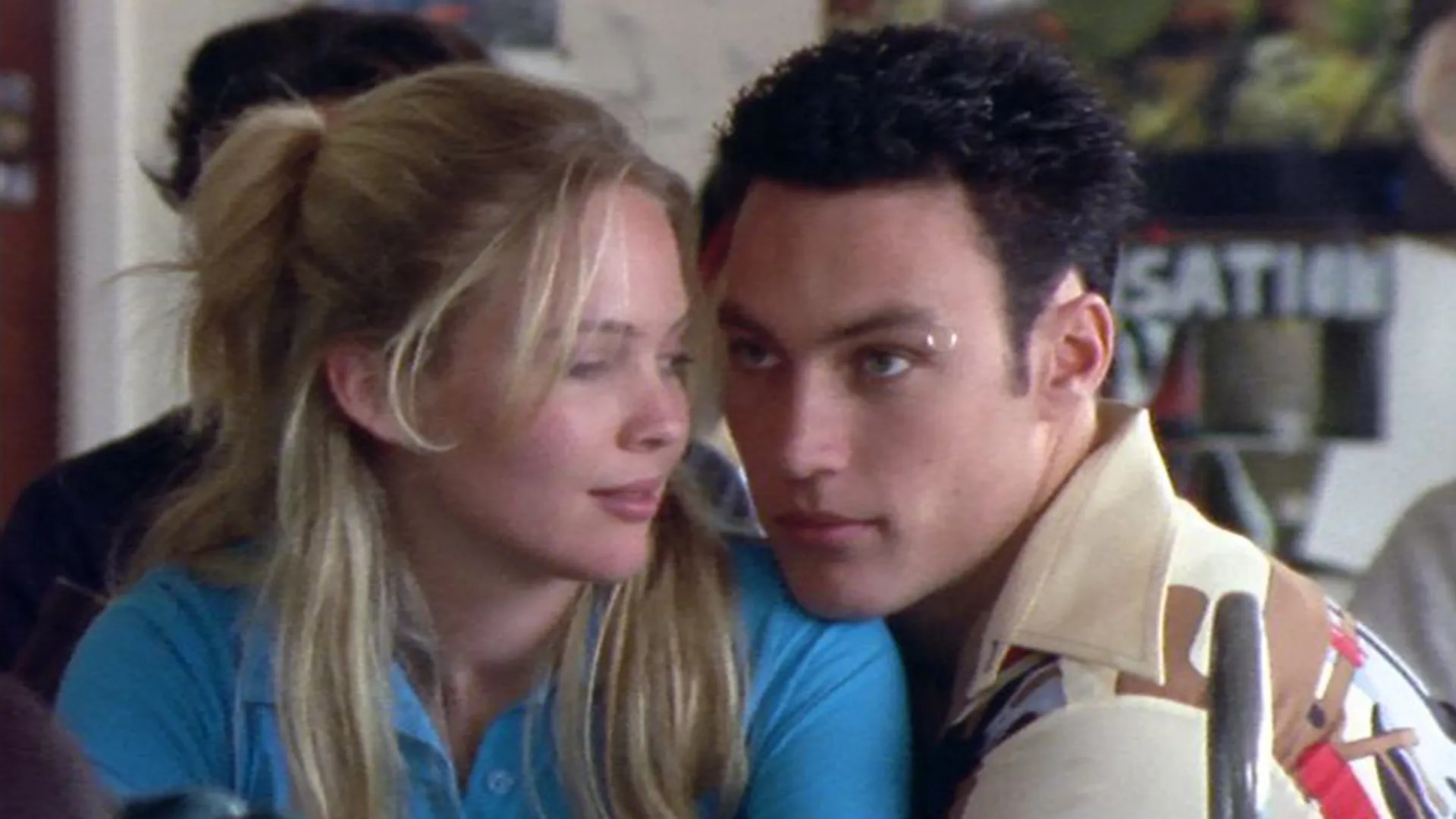 A close-up shot of a man and woman looking at each other intimately.