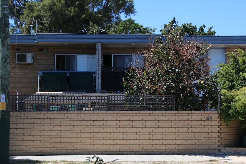 Front view, taken from the street, of a 1960s-style two-storey block of apartments