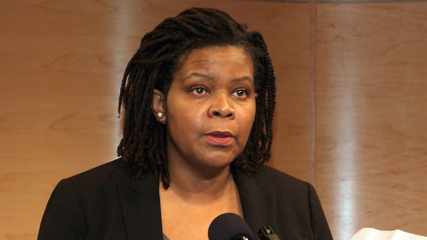 Annette Gordon-Reed, wearing a black blazer, stands at a lectern, delivering a speech from a white sheet of paper
