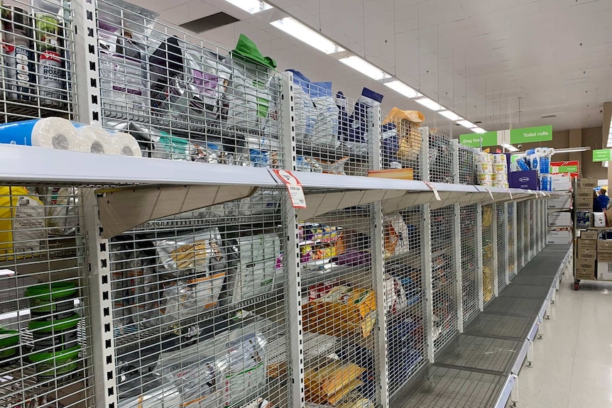 Empty shelves of toilet paper at a supermarket