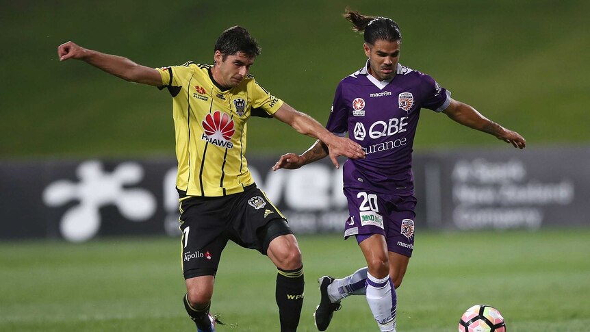 Guilherme Finkler of the Phoenix challenges Aryn Williams of Perth Glory
