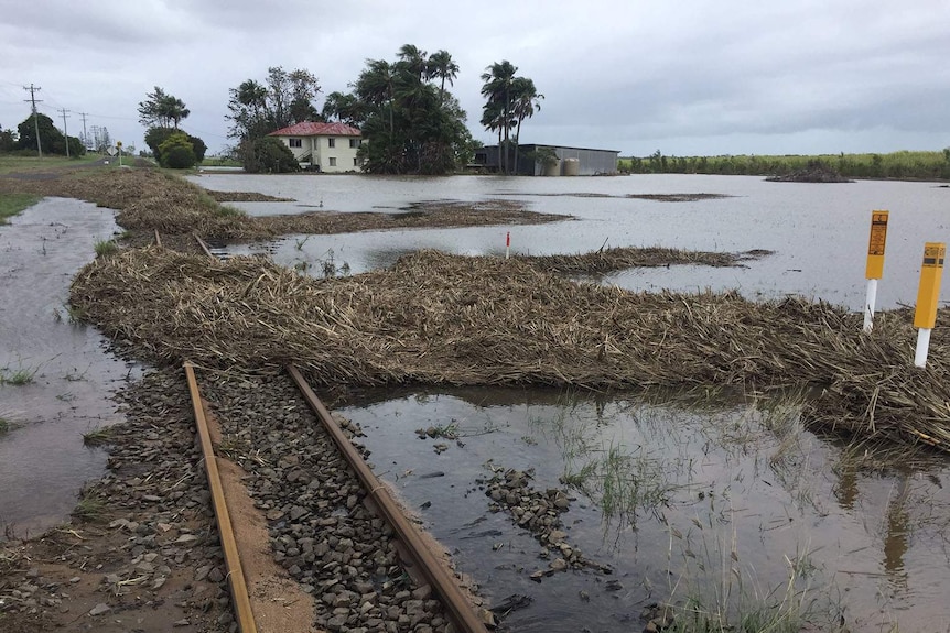 Flood waters drop around Bundaberg house, train track and paddock in southern Queensland on October 19, 2017.