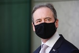 Close up of Hunt, eyes darting across over his black mask.