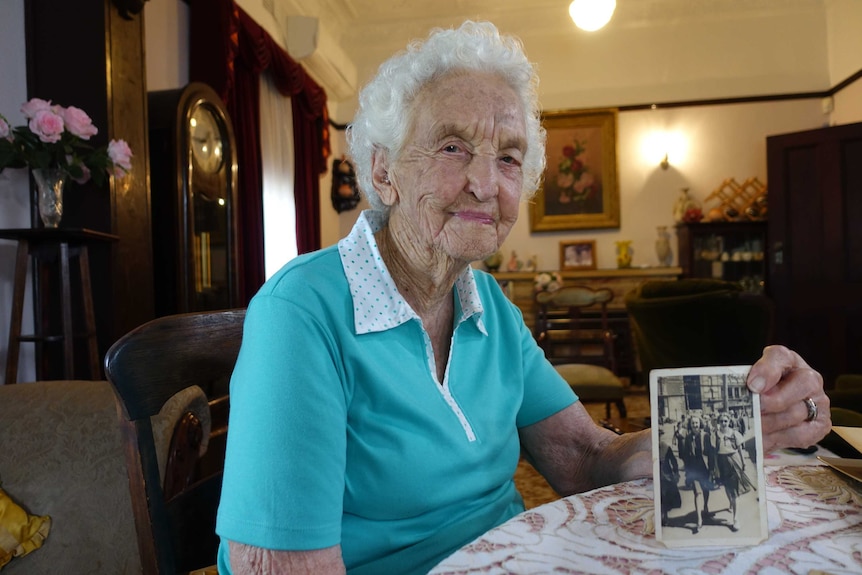 Dorothy Moore, 98, holds a photograph taken in 1936.