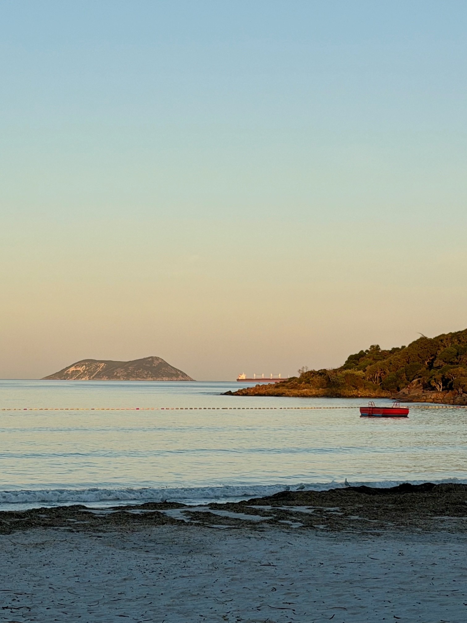 View of an island in the distance with beach in foreground