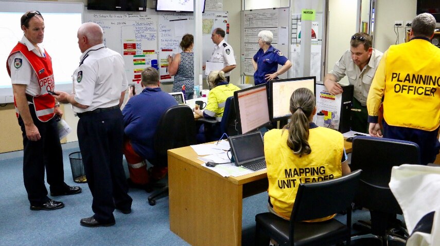 NSW RFS support workers busy at work at the Carwoola fire control centre office.