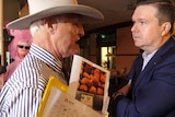 Politicians Bob Katter and Ross Cadell confront each other.