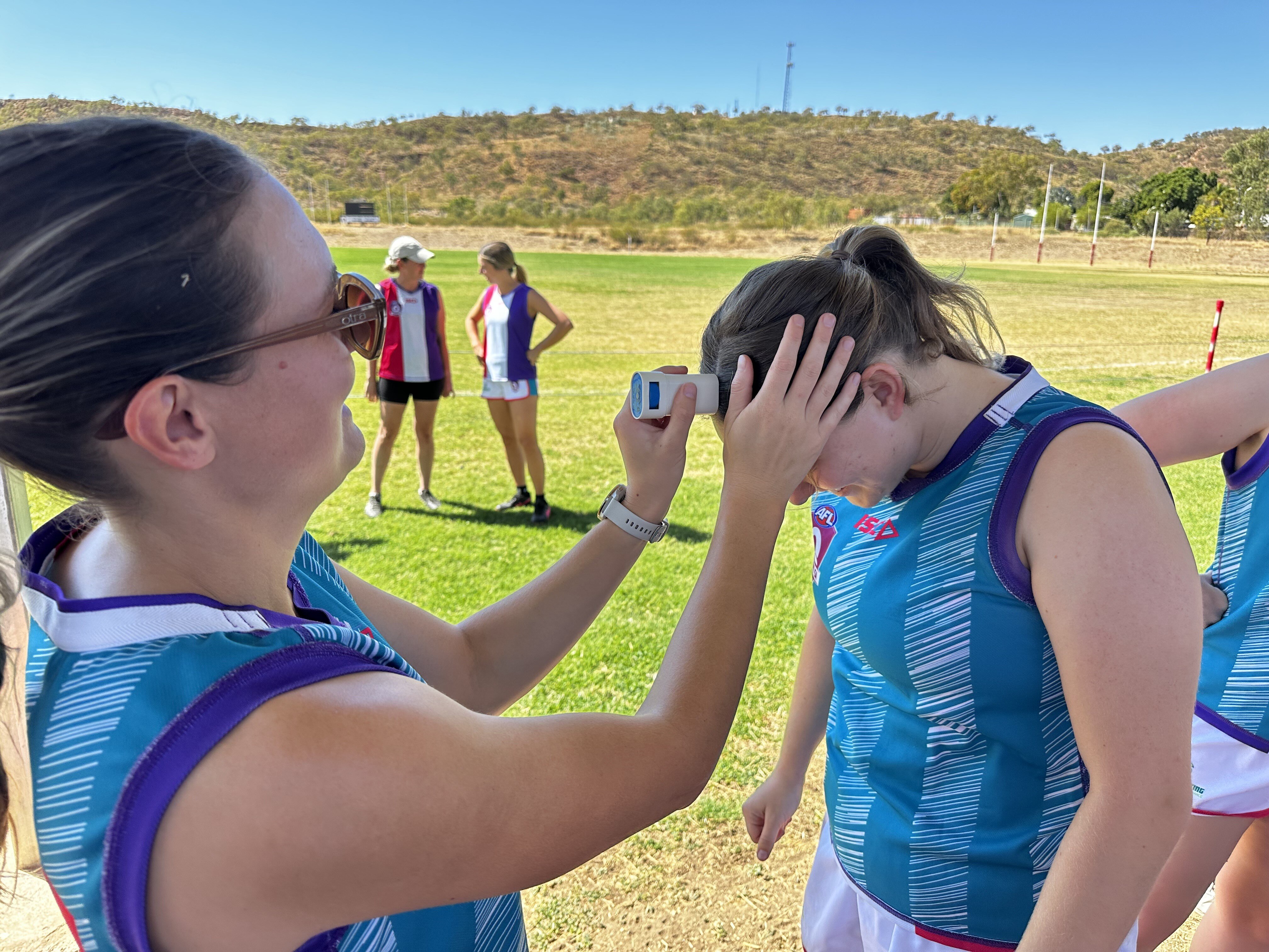 afl girls with sunscreen in their parts