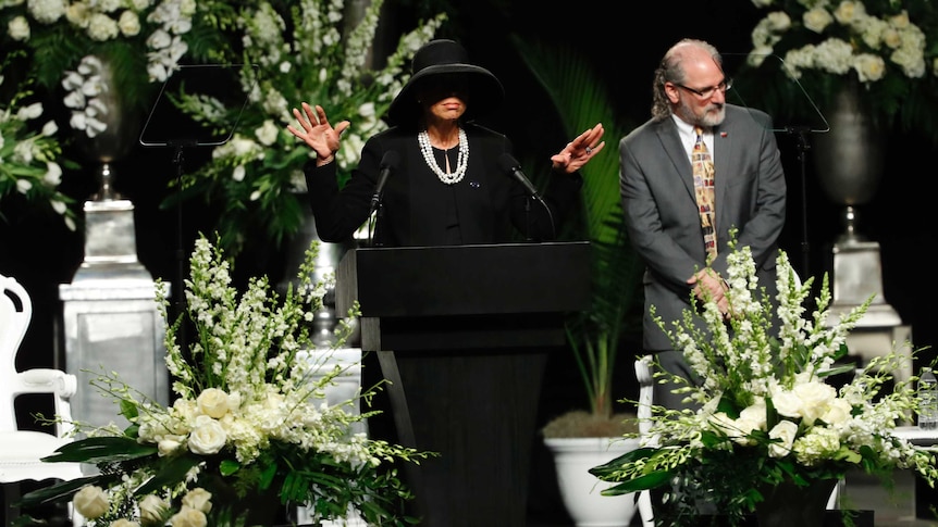 Muhammad Ali's wife, Lonnie Ali, is dressed all in black and speaks during a memorial service.