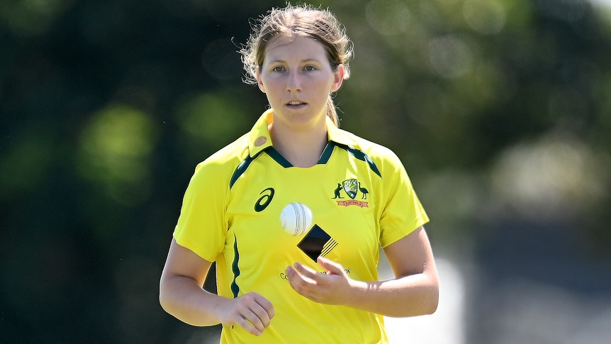 An Australian female cricketer with the ball in an ODI against India.