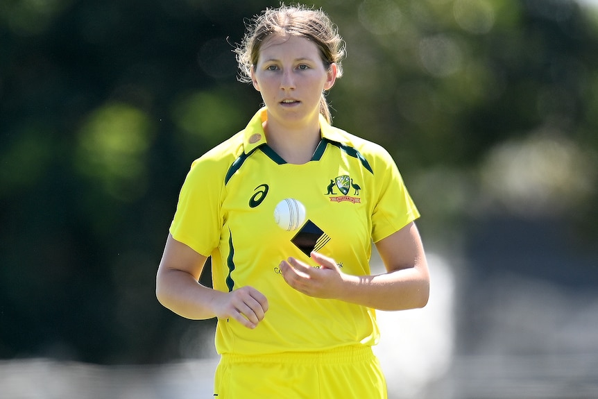 An Australian female cricketer with the ball in an ODI against India.
