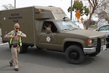 A sheriff's hostage negotiation team passes a California highway patrol checkpoint.