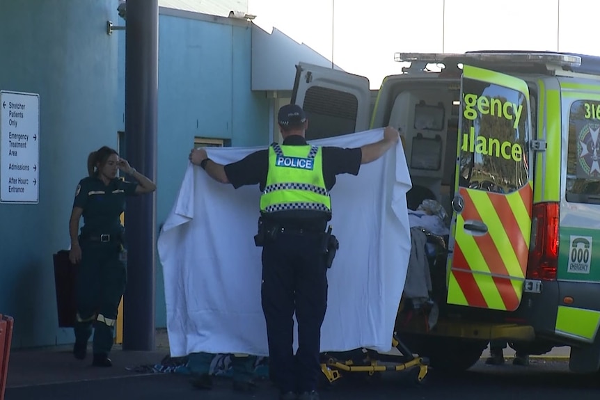 Police and an ambulance outside a hospital.