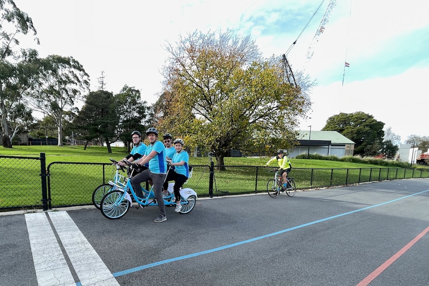 Team of four riding a quadricycle on a track during world record attempt