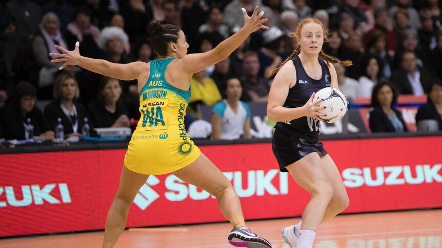 New Zealand's Samantha Sinclair(R) looks to pass against Australia in the Quad Series in Invercargill.