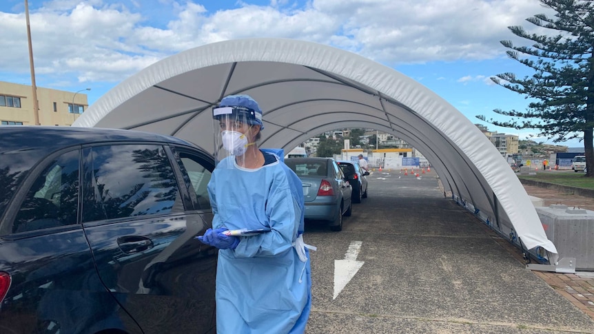 A line of cars drive through to get tested