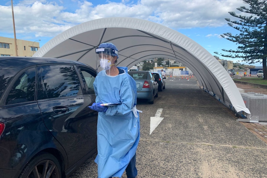 A line of cars drive through to get tested