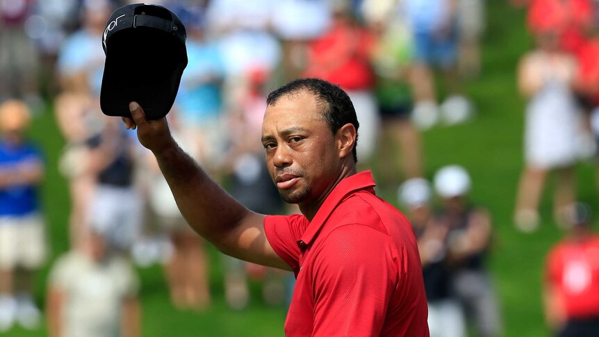 Golfer Tiger Woods acknowledges crowd on 18th hole in final round of 2015 Memorial tournament.