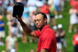 Golfer Tiger Woods acknowledges crowd on 18th hole in final round of 2015 Memorial tournament.