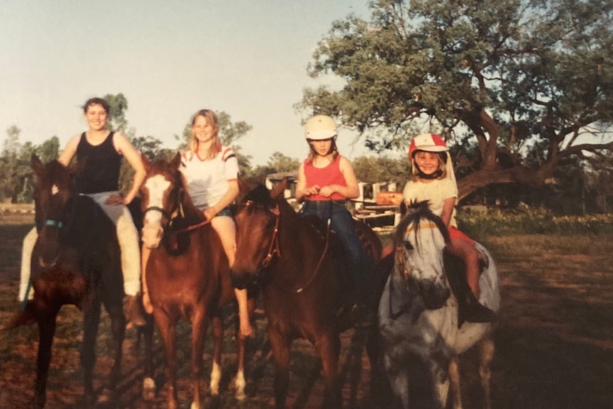 Jodie with her sisters Katie, Tamara and Cailyn riding horses as children.