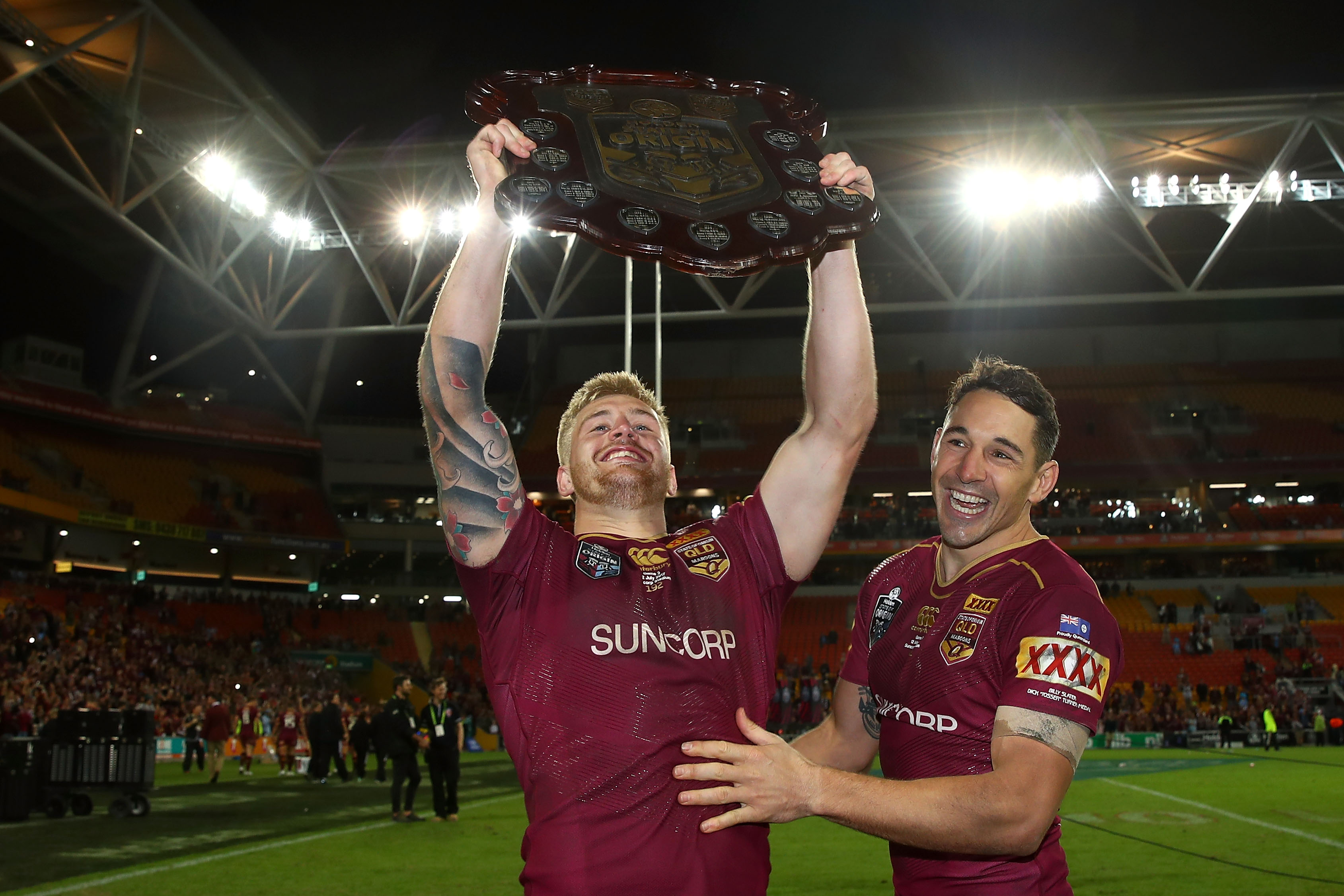Two men celebrate winning the State of Origin series for Queensland 