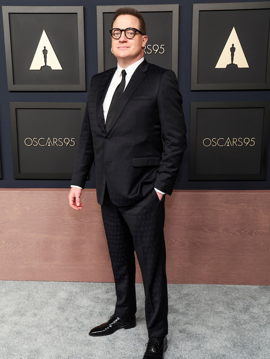 Brendan Fraser stands on the red carpet. 