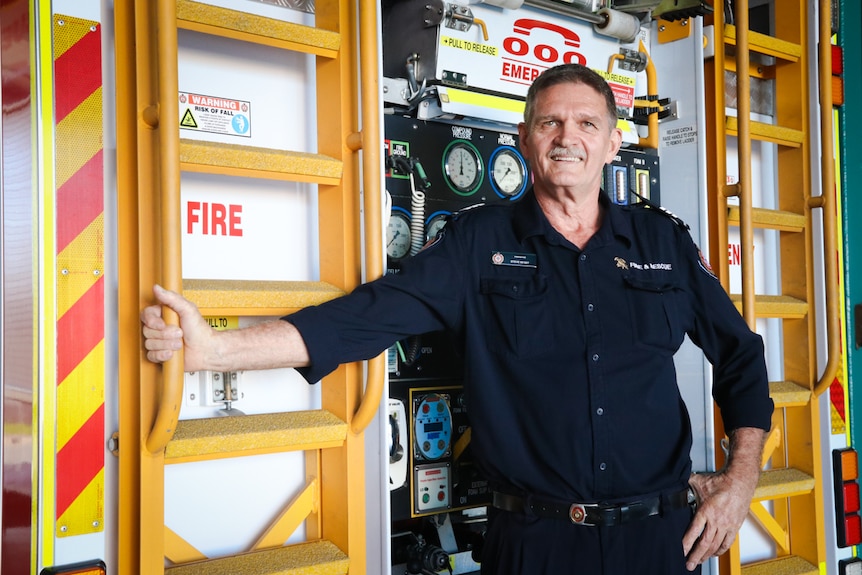 Firefighter in front of engine