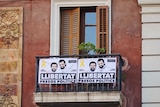 Two election posters on a balcony in Barcelona ahead of the Catalan regional election.