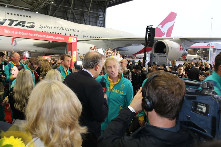 Kim Brennan talks to the media at Sydney Airport