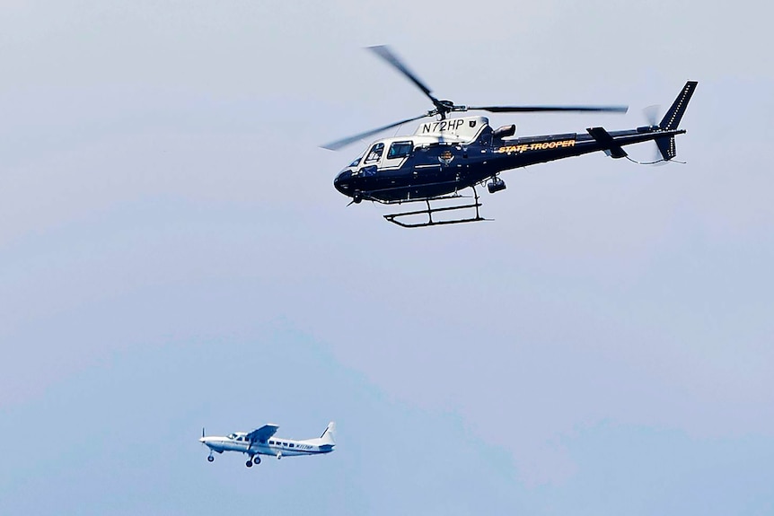 Two small airplanes and an Ohio State Highway Patrol helicopter circle the area.