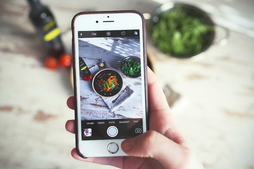 View of a mobile phone used to take a photo of a meal