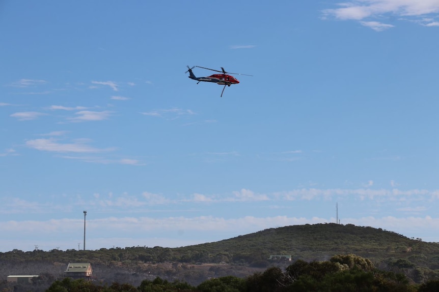 A helicopter water bomber at the scene of a fire near Port Lincoln.