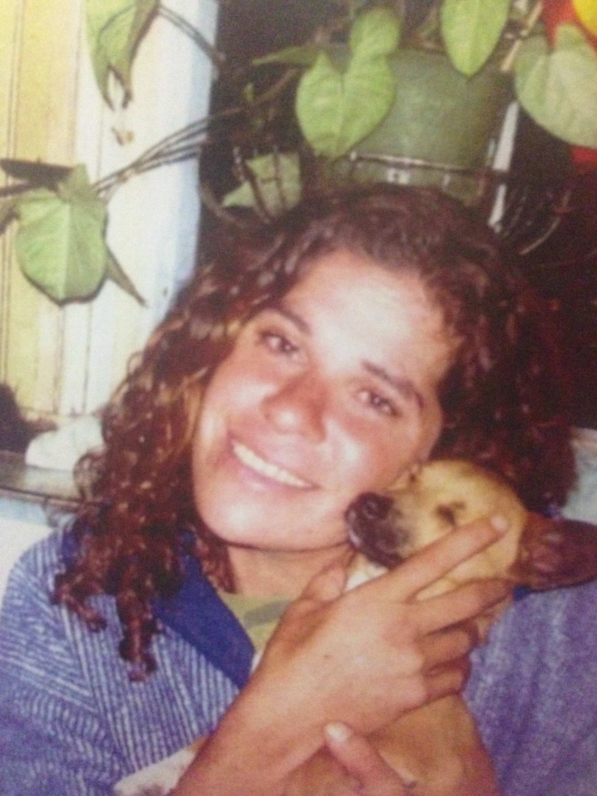 An old photo of Lynette Daly with a pet dog.