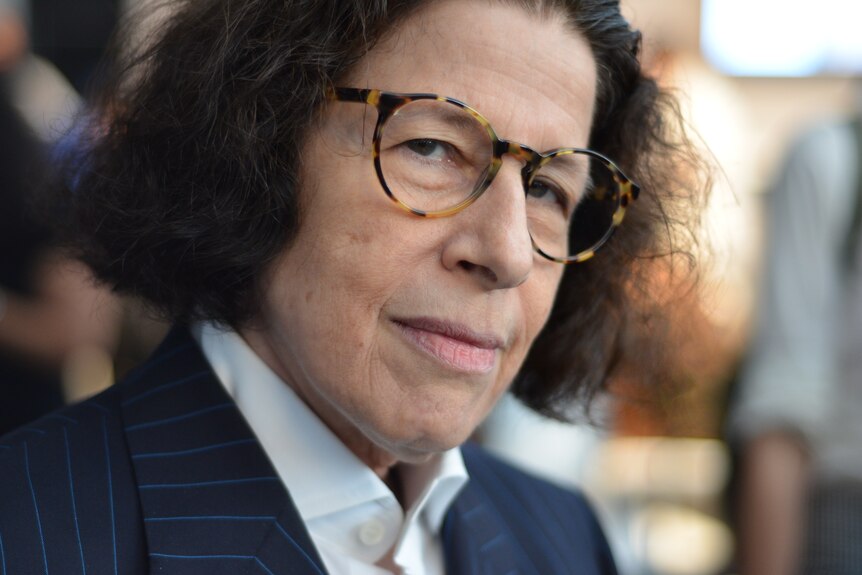 Portrait picture of American author Fran Lebowitz. Fran is wearing a navy blazer and looking directly at the camera.