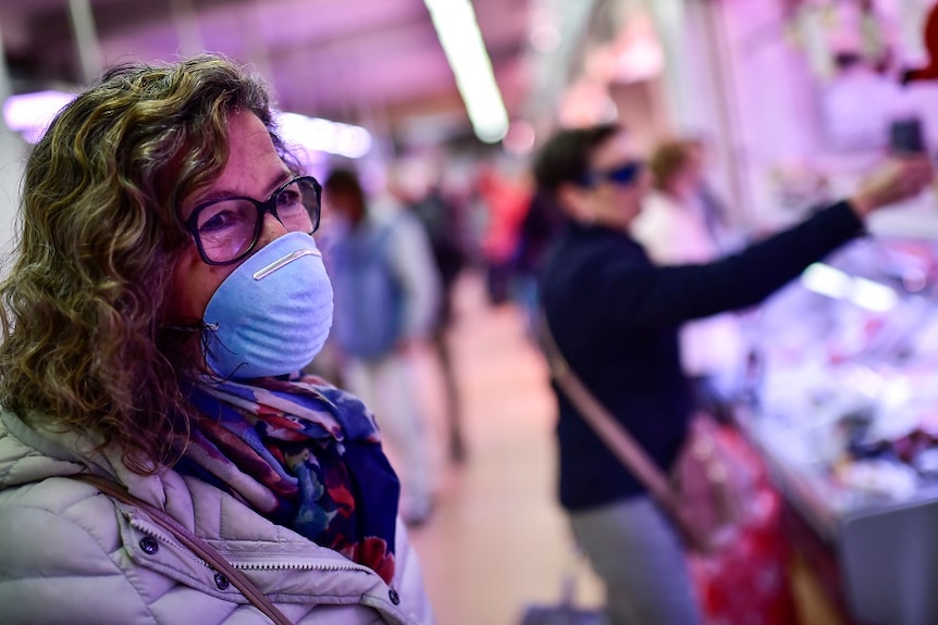 A woman wearing a protective mask.