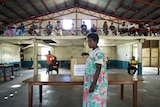 A resident casts her vote at a polling station in Port Vila