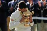 Novak Djokovic kisses the Wimbledon trophy