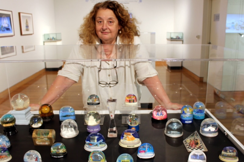 Sally Hopman with snow domes at the All Shook Up exhibition at the Canberra Museum and Gallery