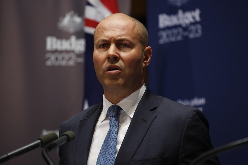 Josh Frydenberg standing in front of budget 2022-23 branding 