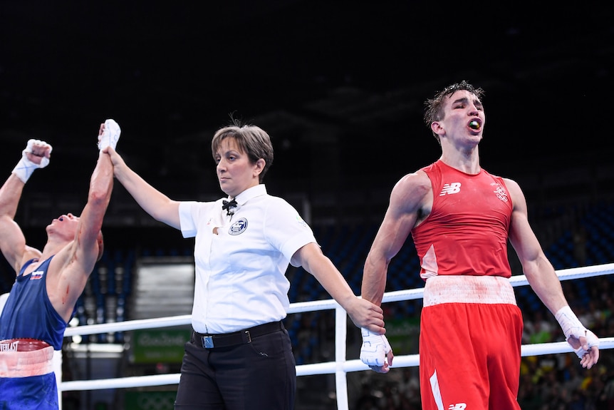 Michael Conlan looks away as Vladimir Nikitin holds his hands up and leans back