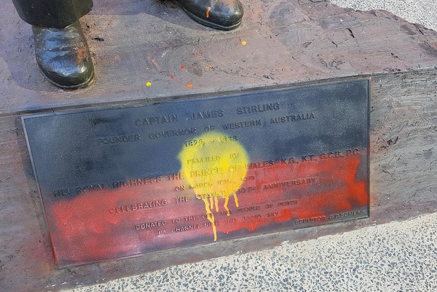 The inscription on the base of the Captain James Stirling statue was painted with an Aboriginal flag.