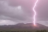 A ligthning bolt strikes the ground at a farm
