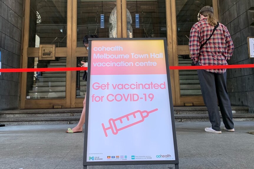 A sandwich board welcome sign outside the Melbourne Town Hall vaccination centre. 
