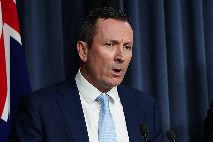 A mid-shot of WA Premier Mark McGowan speaking at a media conference indoors.