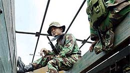 Indonesian soldiers guard an injured Acehnese rebel fighter. (File photo)