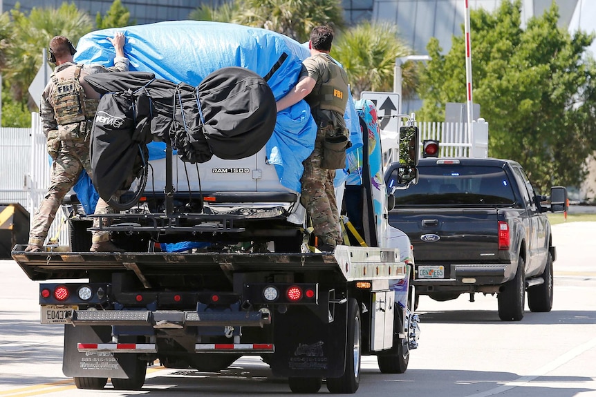 Cesar Sayoc's van is towed into FBI headquarters in Florida.