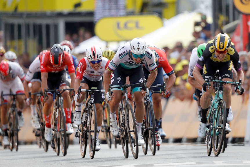 Peter Sagan, Caleb Ewan and Mike Teunissen sprint for the line with grimaces on their faces