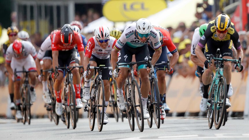 Peter Sagan, Caleb Ewan and Mike Teunissen sprint for the line with grimaces on their faces