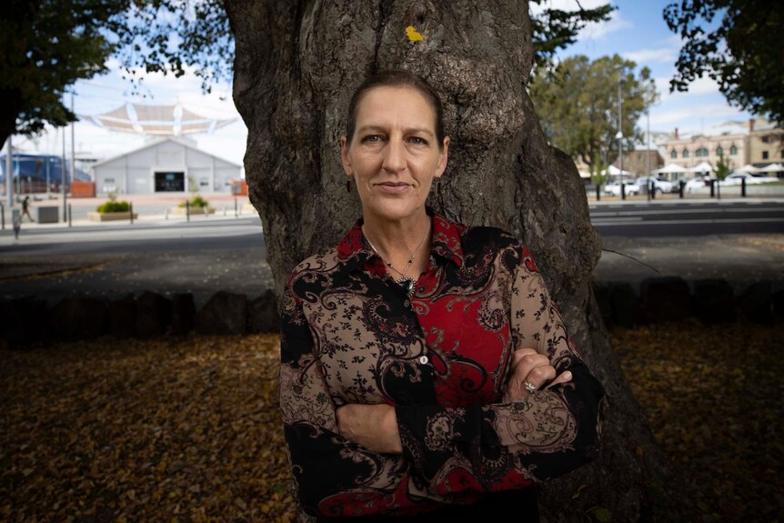 Leader of the Tasmanian Greens, Cassy O'Connor standing in a park in front of a tree.